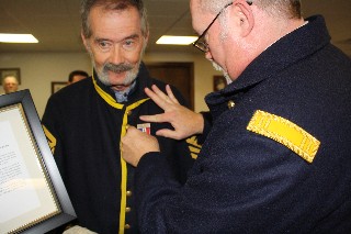 Capt Kane pins on Army of the Tennessee Medal